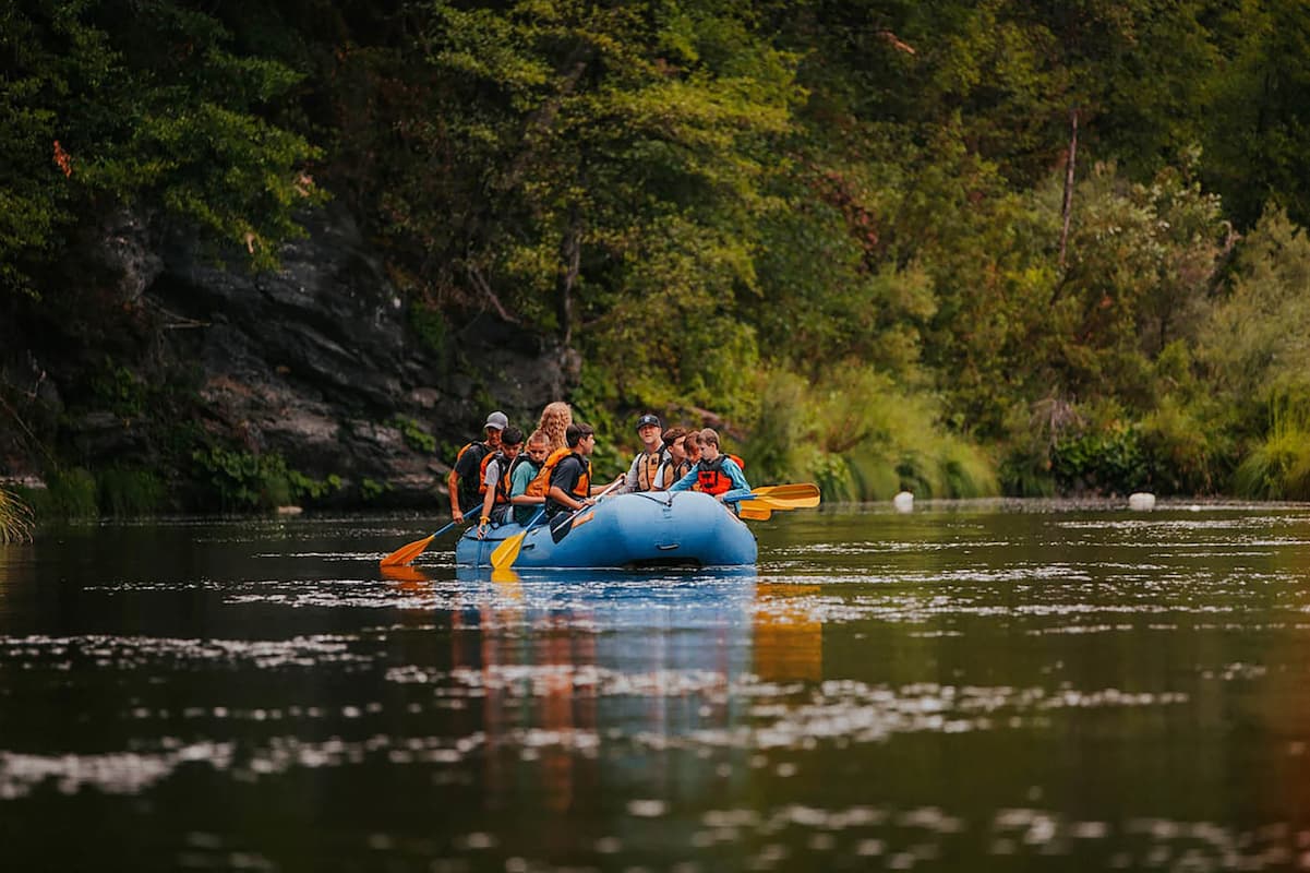 Family enjoying white water rafting adventure together